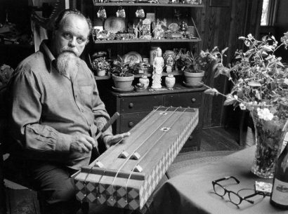 Lou Harrison playing one of his homemade instruments.